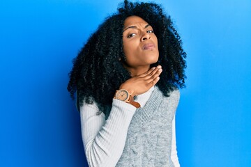 African american woman with afro hair wearing casual winter sweater cutting throat with hand as knife, threaten aggression with furious violence