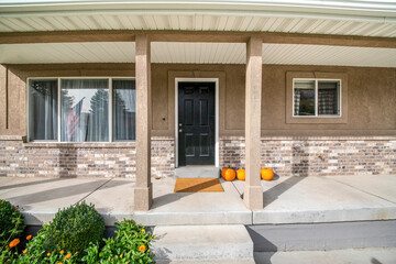 Front door exterior with half brick walls and two column posts in the middle