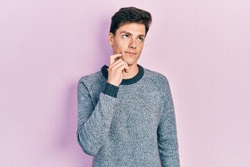 Young hispanic man wearing casual clothes thinking concentrated about doubt with finger on chin and looking up wondering