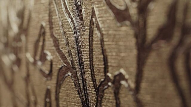 Rolls with wallpaper. Ornament close-up. Stand with wallpaper in the store