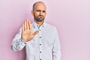 Young hispanic man wearing casual clothes doing stop sing with palm of the hand. warning expression with negative and serious gesture on the face.