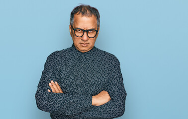 Middle age indian man wearing casual clothes and glasses skeptic and nervous, disapproving...