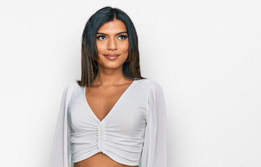 Young latin transsexual transgender woman wearing casual clothes smiling looking to the side and staring away thinking. - obrazy, fototapety, plakaty
