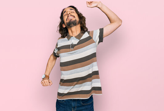 Young hispanic man wearing casual clothes stretching back, tired and relaxed, sleepy and yawning for early morning