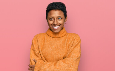 Young african american woman wearing casual clothes happy face smiling with crossed arms looking at the camera. positive person.