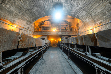 Belt conveyor system in an underground tunnel. Transportation of ore to the surface