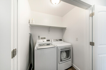 Small laundry closet with folded ironing board and double door