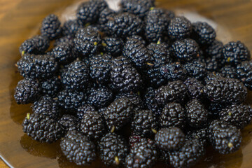 Mulberry  background. Mulberry summer fruit close up drops.