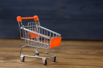 small shopping cart on a wooden table