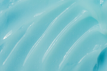 Blue cream, moisturizer, shampoo spread, sunscreen cosmetic smear background. Moisturizing beauty...
