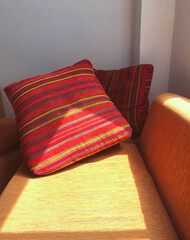 The sofa bed with patterned corners is relaxed and comfortable in the house with the soft morning sunlight.