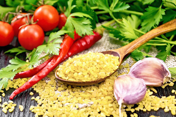 Bulgur in spoon on table
