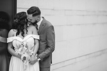 Beautiful newly-married couple posing in a park for the wedding photoshoot