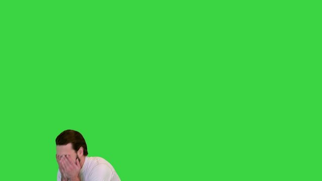 Soccer payer failing to goal and covering his face with his hands on a Green Screen, Chroma Key.