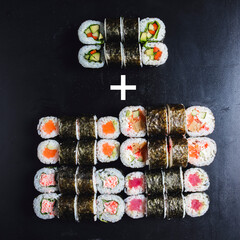 Mix of Japanese nori rolls in on a black background. Advertising campaign, sushi set delivery or take out