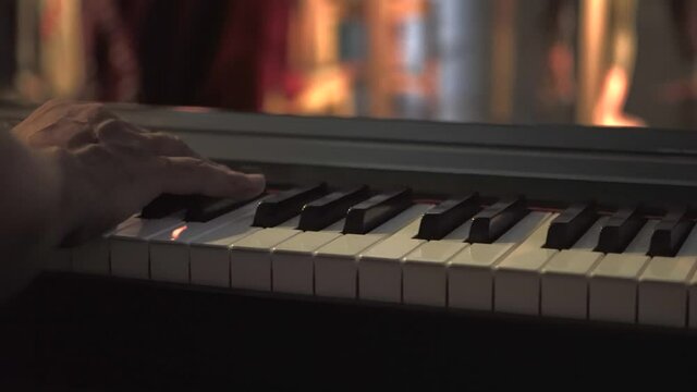 Male Hands Playing Piano Gracefully In Circo de los Ninos, San Pancho, Mexico. close up, slider left