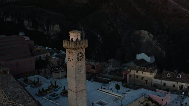 People Walking Around The Iconic Torre De Mangana At Sunrise In The City Of Cuenca In Spain. drone pullback