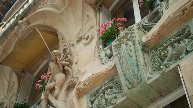 Details Of Ceramic Sandstone Sculpture At The Balcony Of Lavirotte Building In Paris, France. Apartment Building With Art Nouveau Architecture. low angle, slider right