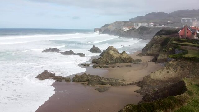 Aerial drone view of the beach of Bakio in the Basque Country in a foggy day