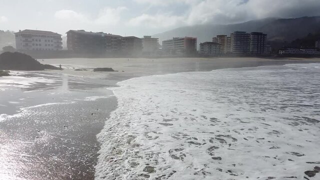 Aerial drone view of the beach of Bakio in the Basque Country in a foggy day