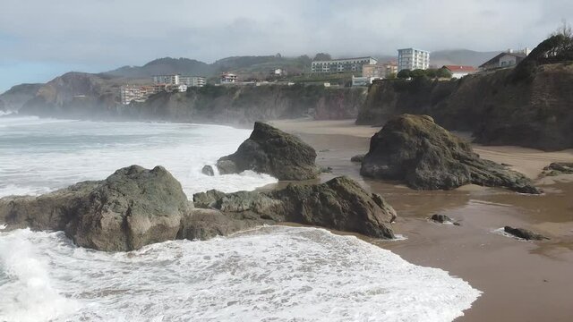 Aerial drone view of the beach of Bakio in the Basque Country in a foggy day