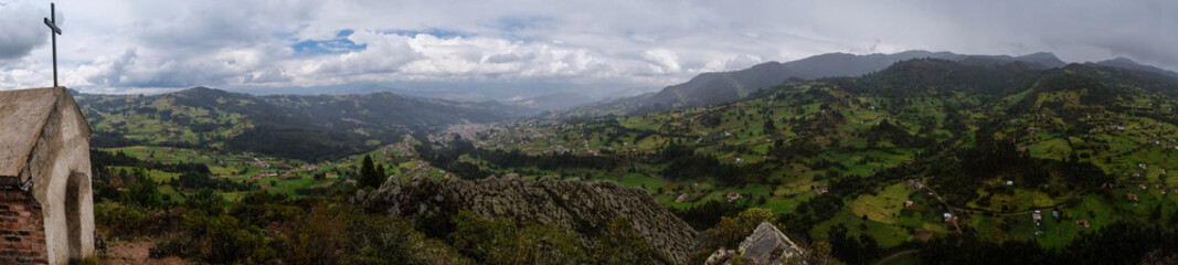 Obraz premium panoramic view of a chapel on a mountain with other mountains in the background