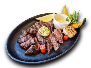 Steak with medium rare in plate with garlic herb lemon pumpkin side dish and signature sauce on white background die cut with clipping path