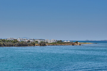 Fototapeta na wymiar Antiparos island, Greece - June 2017: Beautiful seascape view travelling to Antiparos island as the boat approaches the port. Panoramic summer scenery in Greece at Antiparos island, Cyclades, Greece