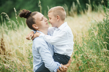 the mother holds a smiling child in her arms 