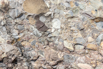 Closeup shot of conglomerate stone texture - obrazy, fototapety, plakaty
