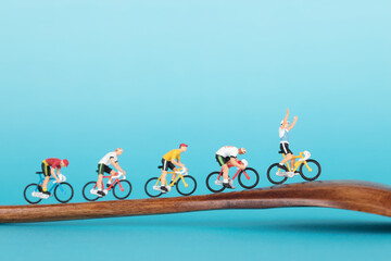 A team of cyclists miniatures on wooden spoons
