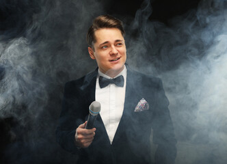 Stylish young showman with microphone