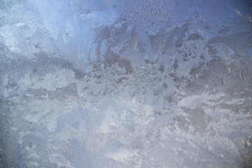 Textured frost patterns on the glass. Ice crystals on the window on a cold, frosty day in winter.