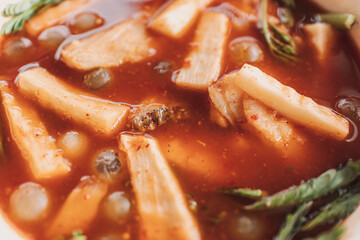 Thai Ryukyu Roe Sour Soup served in white bowl on white table.