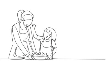 Single one line drawing mother feeds her little daughter food and in front of her is bowl filled with salad. Cooking together in cozy kitchen. Continuous line draw design graphic vector illustration