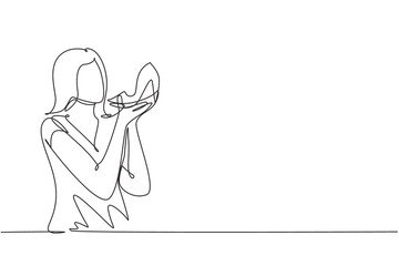 Continuous one line drawing addicted from high heels, young woman kissing her new shoes.