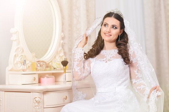 young beautiful bride in white dress posing