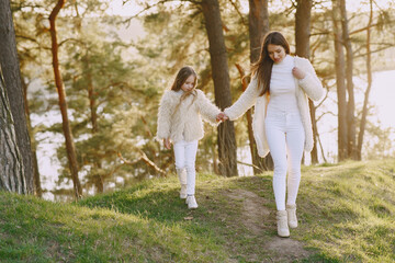 Fototapeta premium Elegant mother with daughter in a summer forest