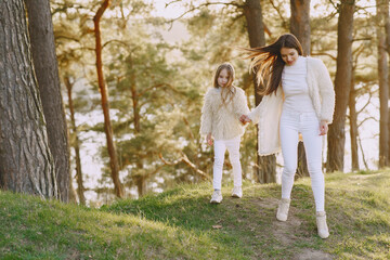 Fototapeta premium Elegant mother with daughter in a summer forest