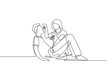 Continuous one line drawing romantic couple having picnic in summer park. Relaxing together sitting on the ground and women feeding grapes to men. Single line draw design vector graphic illustration