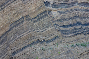 different layers of rock in a rocky wall