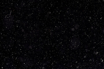 Night sky with brightly shining stars, white snow on black background