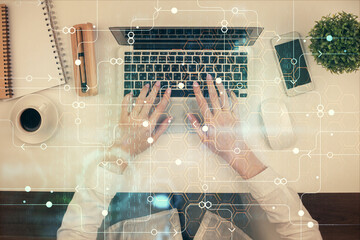Double exposure of woman hands working on computer and data theme hologram drawing. Top View. Technology concept.