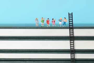 A row of miniature pupil models on the book