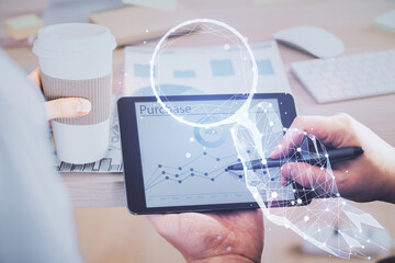 Double exposure of man's hands holding and using a mobile device and creative hologram drawing.