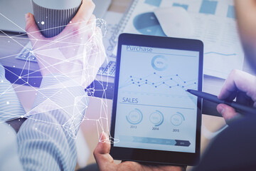 Double exposure of man's hands holding and using a mobile device and creative hologram drawing.