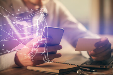Double exposure of man's hands holding and using a mobile device and creative hologram drawing.