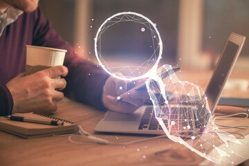 Double exposure of man's hands holding and using a mobile device and creative hologram drawing.