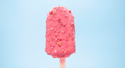 popsicle stick strawberry isolated on blue background.