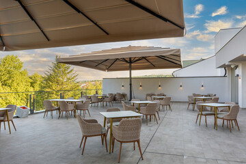 Empty terrace hotel restaurant with sun shades
